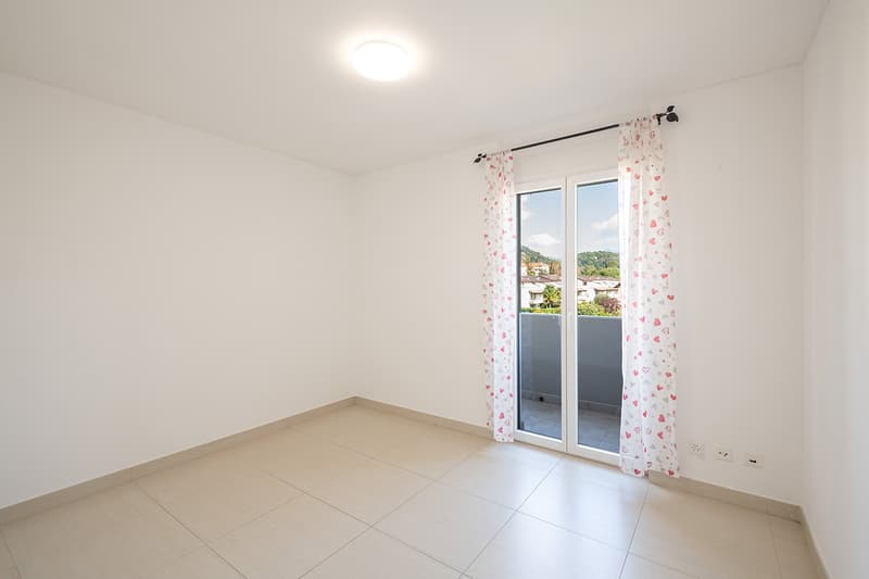 empty room, white walls, tiled floor, sliding glass door, balcony