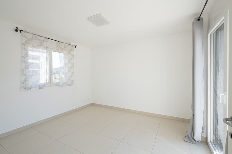 empty room, white walls, white tile floor, two windows with curtains, ceiling light
