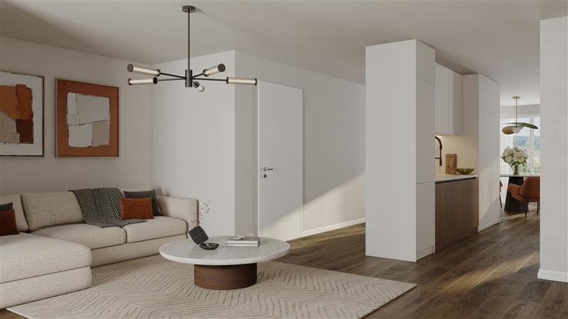 white sofa, round coffee table, chandelier, white floor, open kitchen area