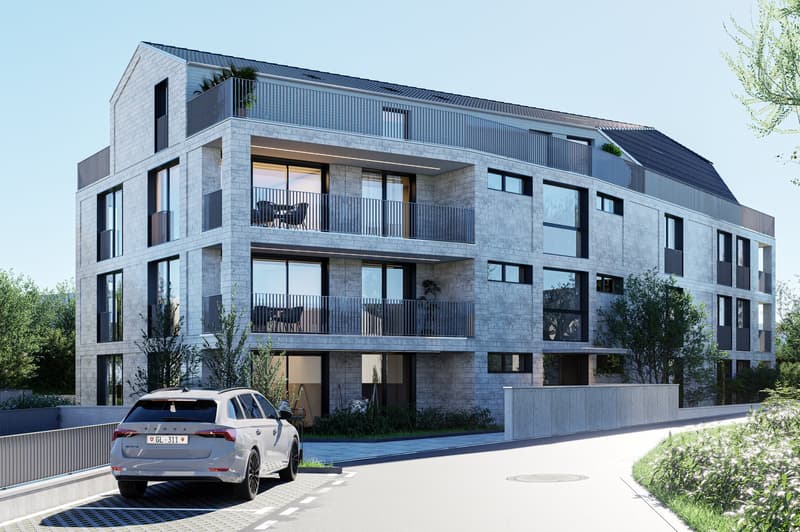 Modern apartment building with balconies, gray stone facade, large windows, car parked in front