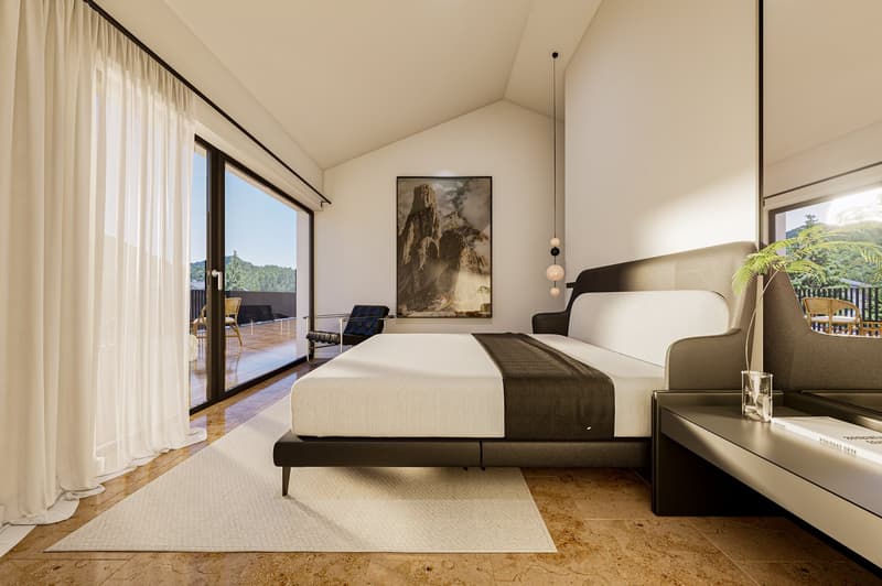 modern bedroom with large bed, white walls, large windows, balcony, rug, bedside table, artwork
