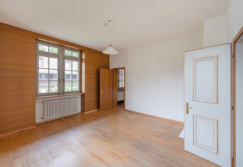 empty room, wooden floor, wooden walls, white walls, window, radiator, door