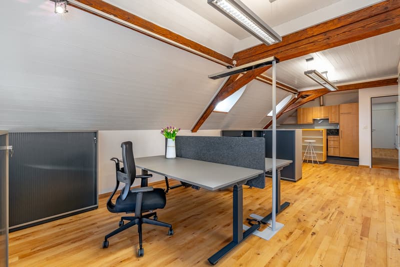 office room with wooden floor, wooden beams, office desk, office chair, flower vase, office partition