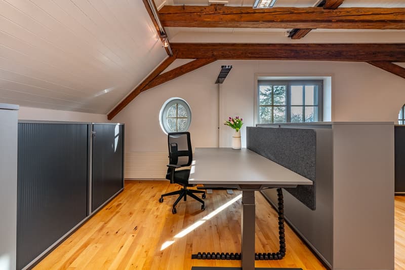 wooden floor, wooden beams, office desk, office chair, round window, window, flower vase