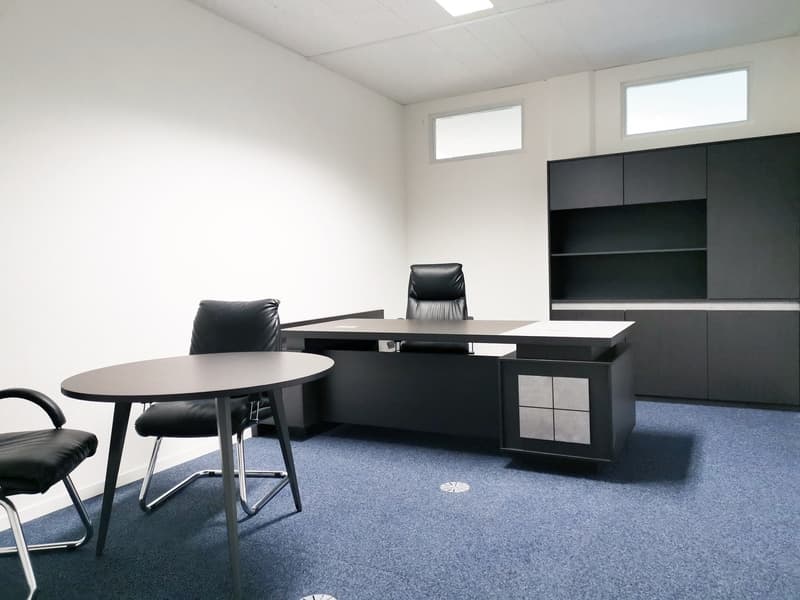 modern office with a desk, 3 chairs, a round table, and a cabinet