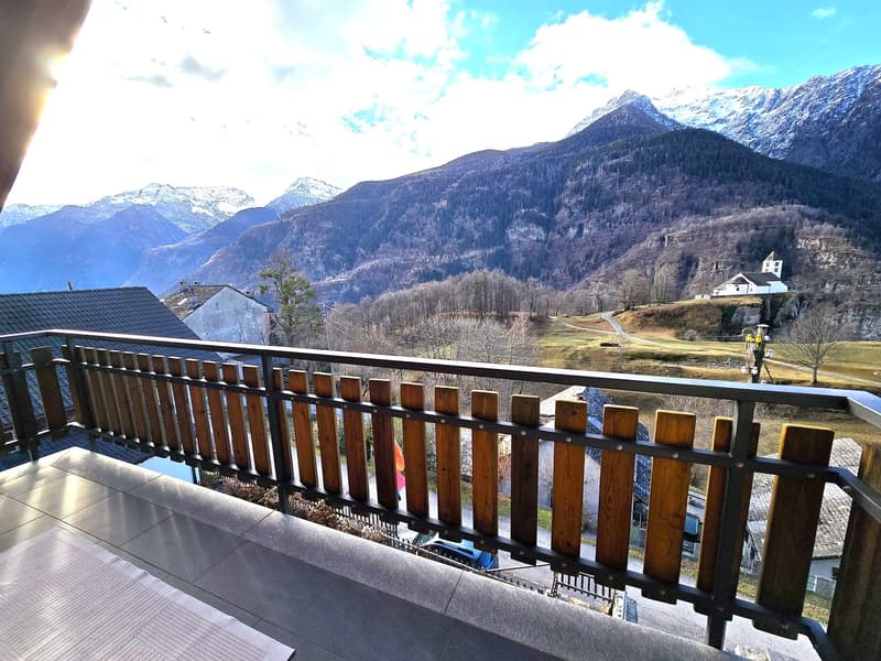 wooden railing, tiled floor, metal railing, mountain view, clear sky