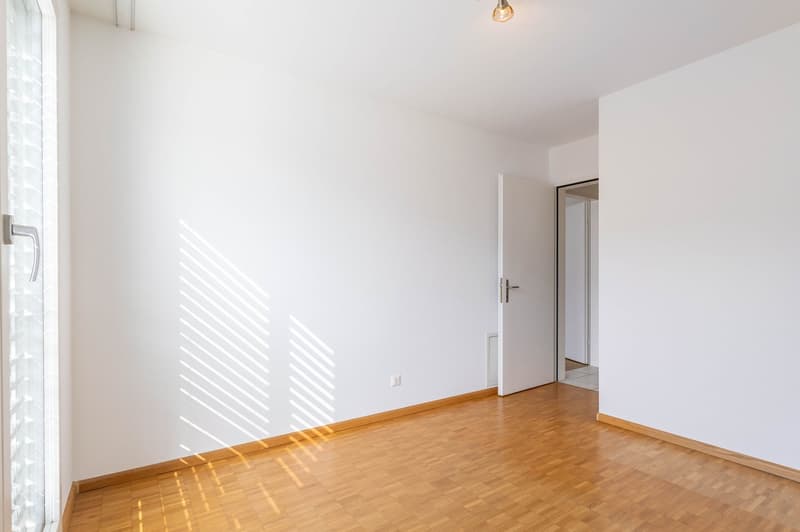 empty room, wooden floor, white walls, open door, light coming from outside
