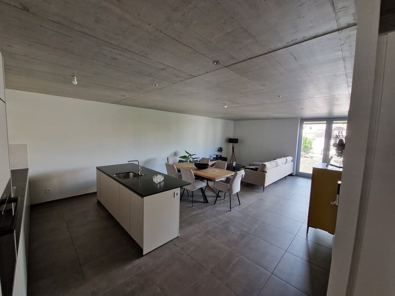 modern kitchen with island, dining table, living room with couch, open floor plan, white walls, tiled floor