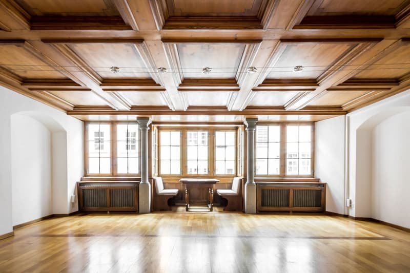 wooden floor, wooden ceiling, large windows, wooden table, wooden benches, radiators