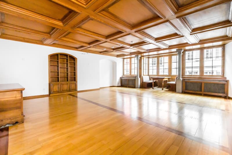 large room, wooden floor, wooden ceiling, large windows, wooden cabinet, wooden desk, radiators