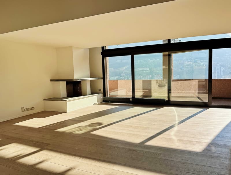 large room with wooden floor, fireplace, sliding glass doors, balcony, city view