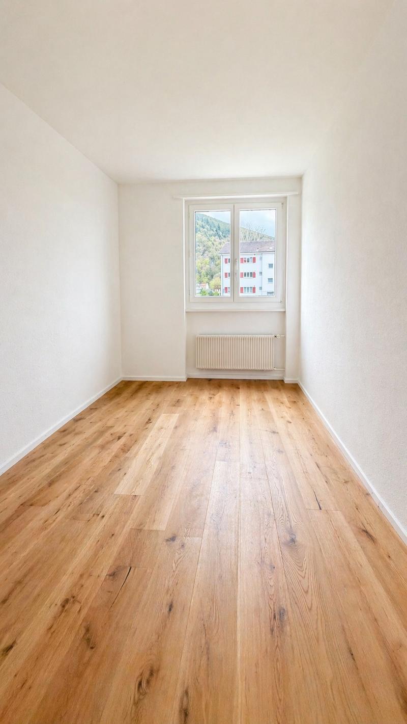empty room, wooden floor, white walls, window with view, radiator