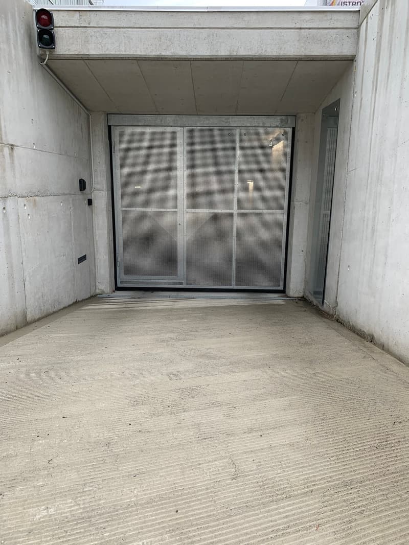 concrete walls, metal sliding door, concrete floor