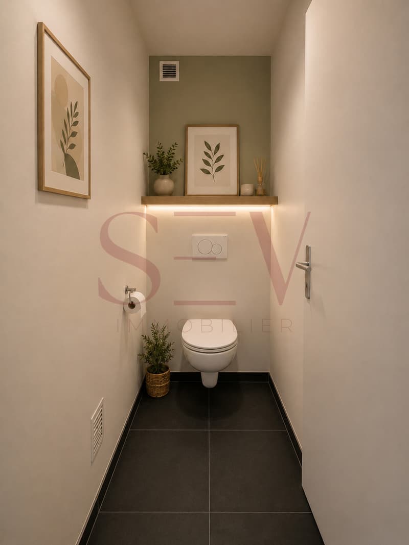 WC visiteurs / a small bathroom with a white toilet, black floor and pictures on the wall