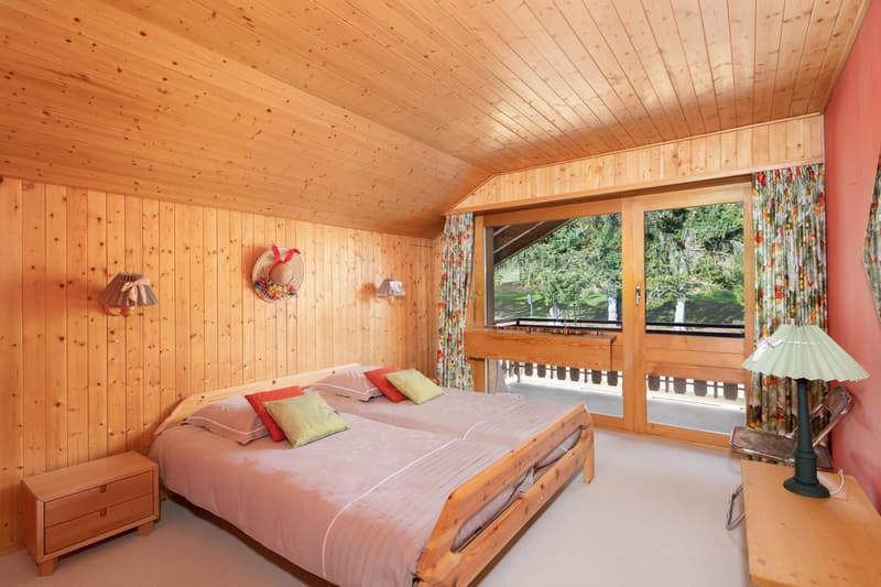 wooden walls, wooden bed, wooden nightstand, wooden table, lamp, balcony, large windows, view