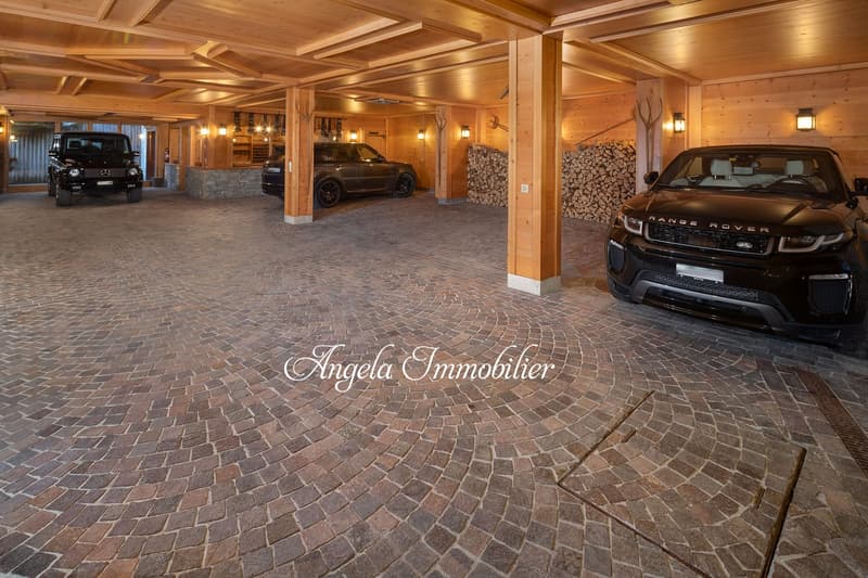 wooden ceiling, brick floor, three cars parked, wooden pillars, wooden walls, lights