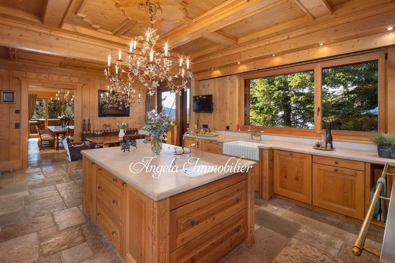 large kitchen with wooden cabinets, granite countertop, chandelier, sink, faucet, large windows, dining area