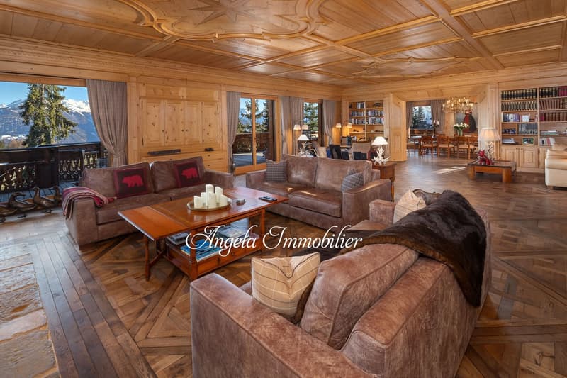 wooden ceiling, wooden floor, large windows, balcony, sofa, coffee table, fireplace, bookshelves, chandelier