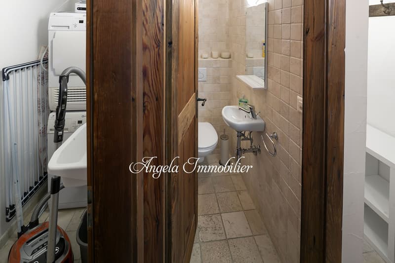 Bathroom with sink, toilet, and washing machine and dishwasher