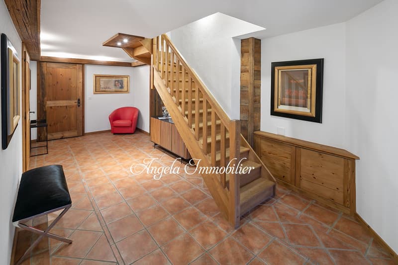 wooden staircase, wooden floor, white walls, red chair, wooden bench, picture frames