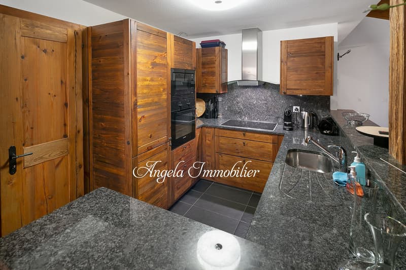 modern kitchen with wooden cabinets, granite countertops, stainless steel appliances, double oven, dishwasher, washing machine, granite flooring