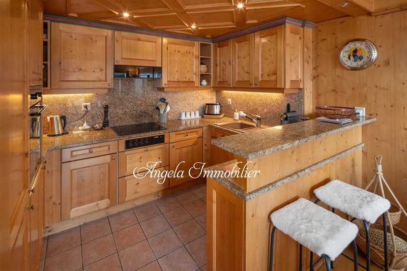 kitchen with granite countertop, wooden cupboards, sink with faucet, stove, refrigerator, toaster, basket, clock