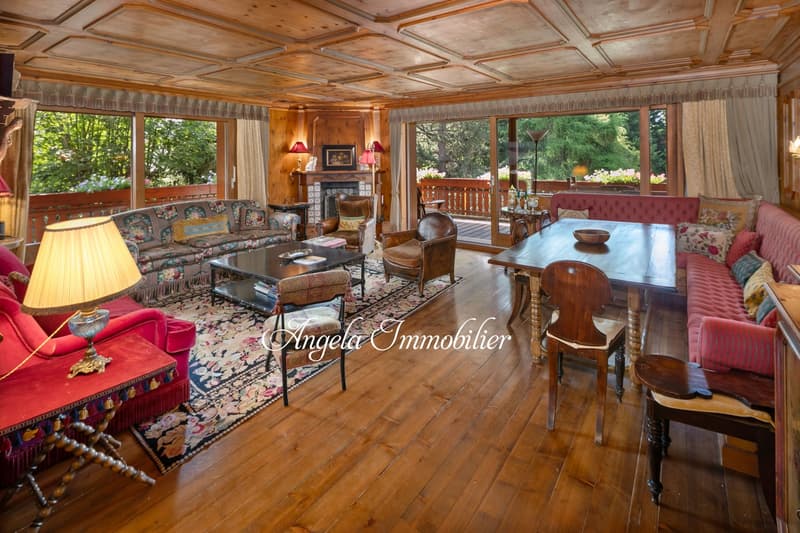 wooden floor, large windows, fireplace, sofa, coffee table, dining table, chairs, lamps, rug