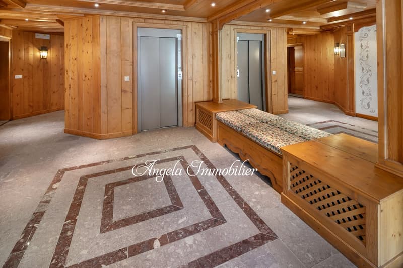 wooden walls, two elevators, wooden benches, tiled floor