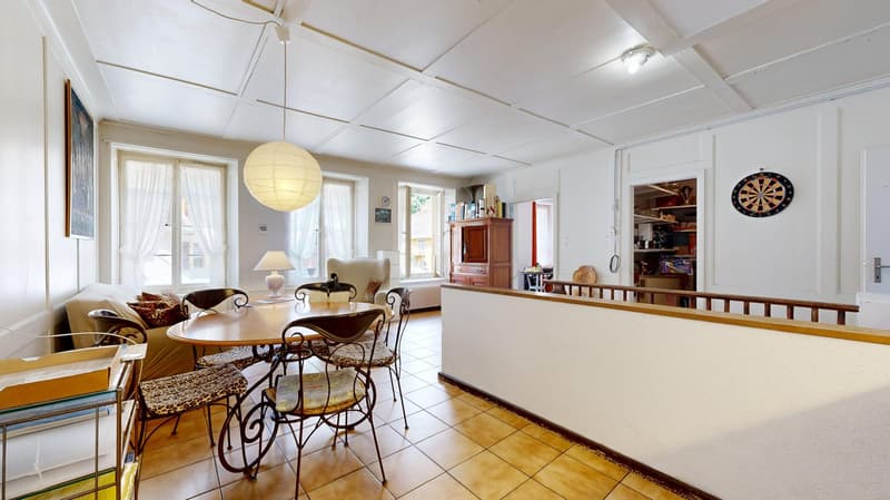 dining room, round table, 4 chairs, wooden cabinet, couch, wooden railing