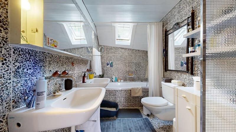 2 sinks, bathtub, toilet, shelves, and mirrors