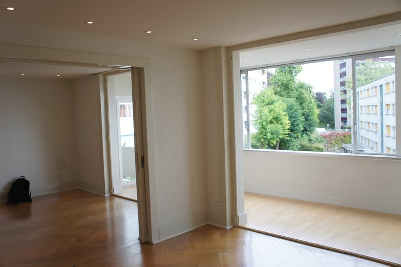 empty room, wooden floor, white walls, large windows, balcony
