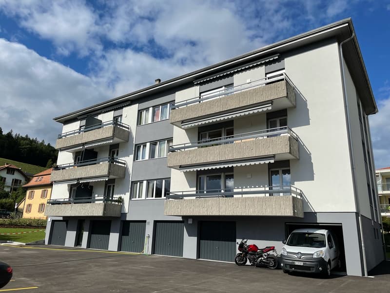 Three story building, multiple balconies, underground garage, modern design, large windows