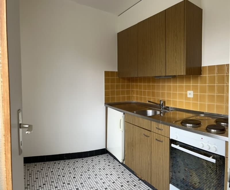 kitchen, stainless steel sink, countertop, tiled flooring, wooden cabinets, gas stove, oven, tiled wall