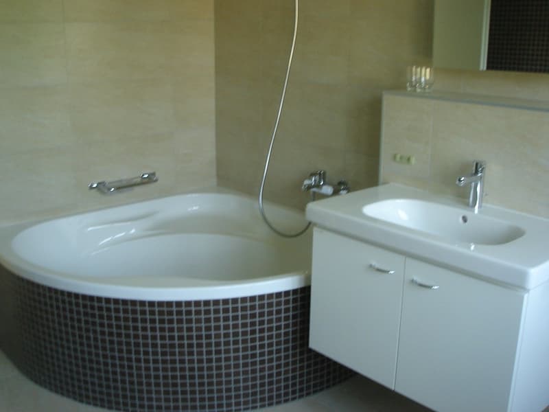 Bathroom with bathtub, sink, and shower head