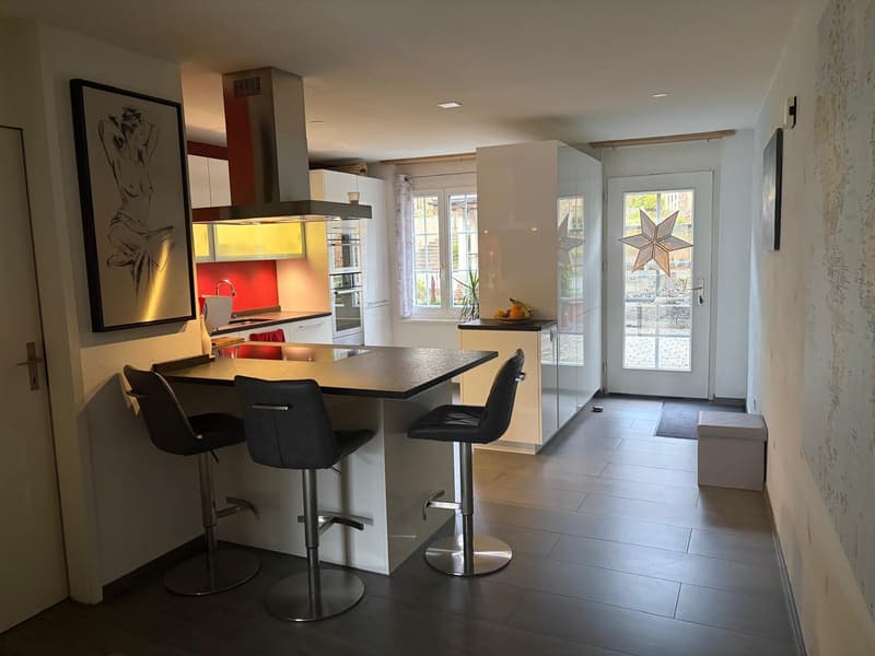 modern kitchen with island, 3 bar stools, white cabinets, yellow cabinets, stainless steel appliances, large windows, tiled floor