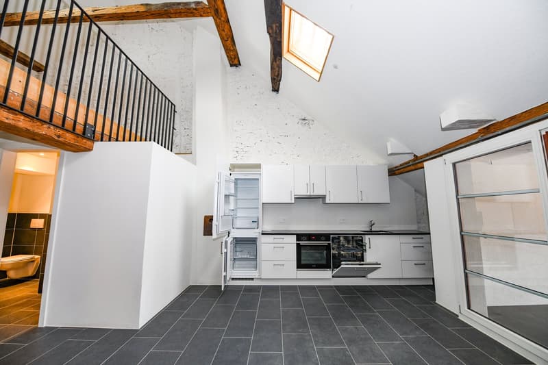 open kitchen, white appliances, black tiles