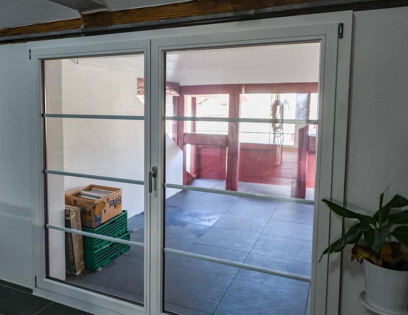 room with storage boxes, sliding glass door