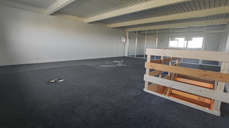 empty room, white walls, gray floor, wooden stairs, glass doors, windows