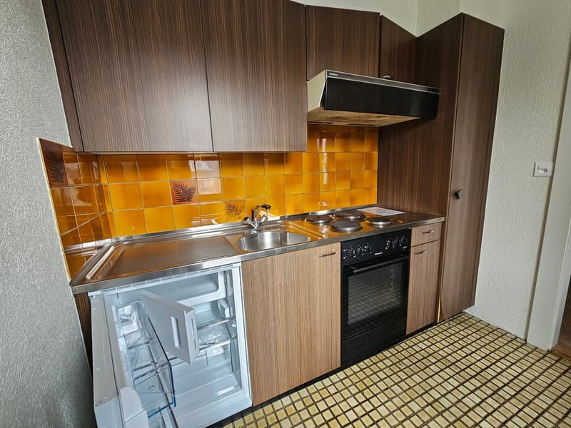 small kitchen with stove, sink, refrigerator, cabinets, tiled flooring, yellow tiles
