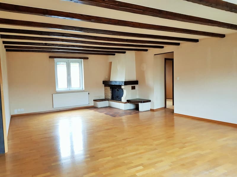 wooden floor, ceiling beams, fireplace, radiator, window
