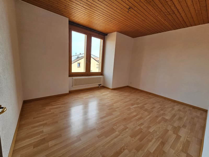 empty room, wooden floor, white walls, wooden ceiling, large window, white radiator
