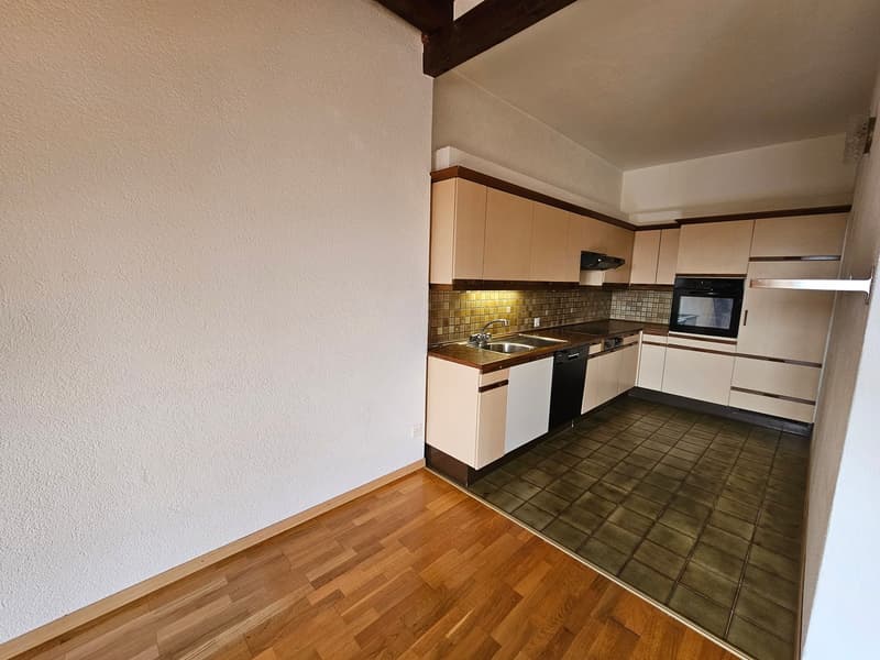 modern kitchen with wooden floor, white walls, built-in cabinets, sink, oven, dishwasher, and countertop
