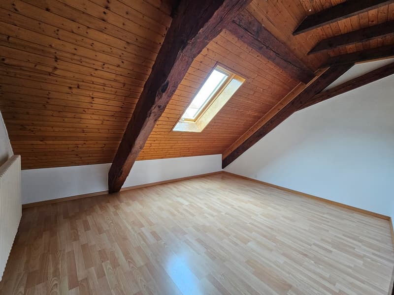 wooden ceiling, wooden floor, skylight, white walls, radiator