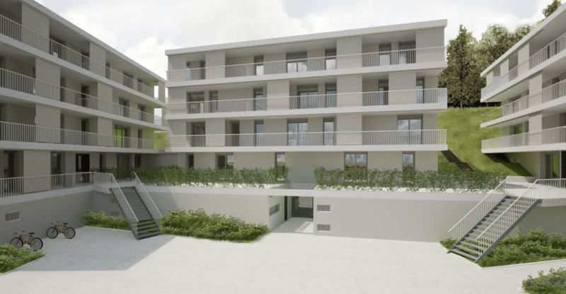 4-story apartment building with white exterior, balconies, and parking spaces in the courtyard