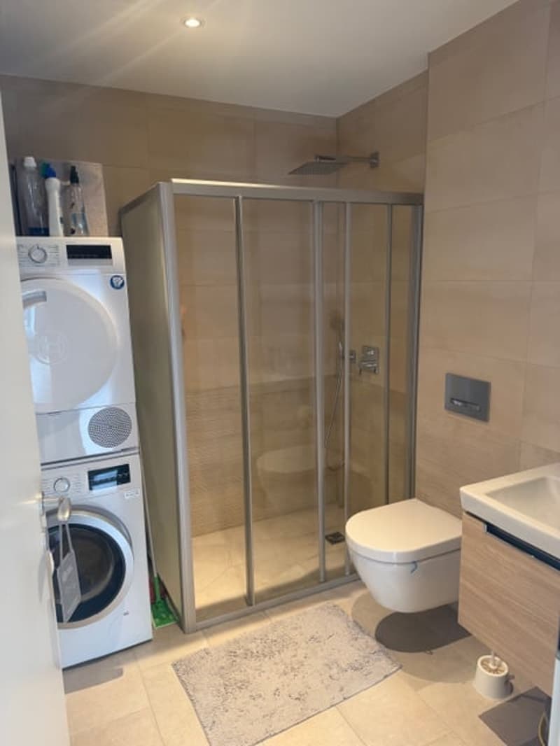 Private washing machine, shower, toilet, sink, tiled flooring