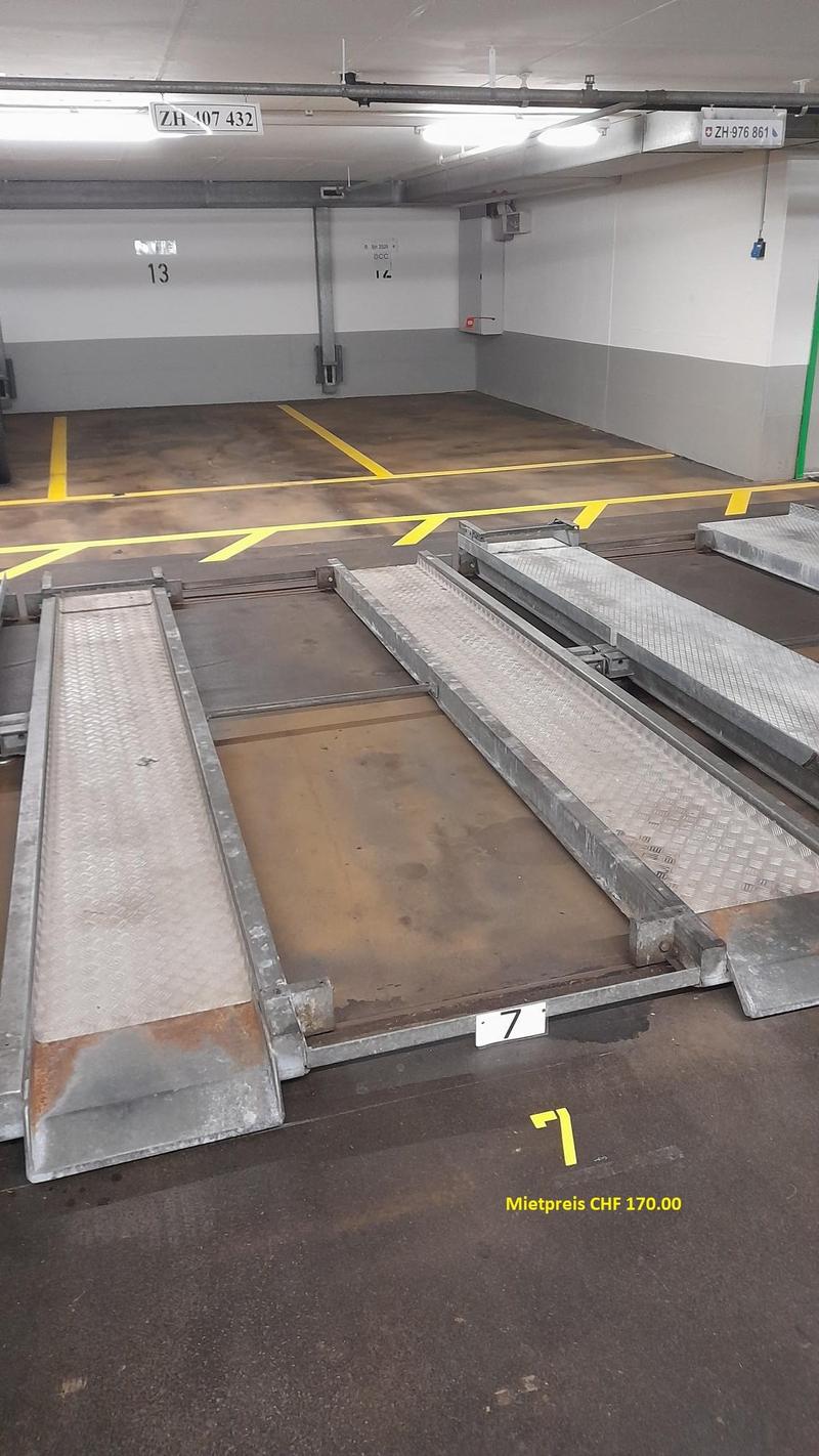 underground parking lot, metal ramps, yellow markings, empty