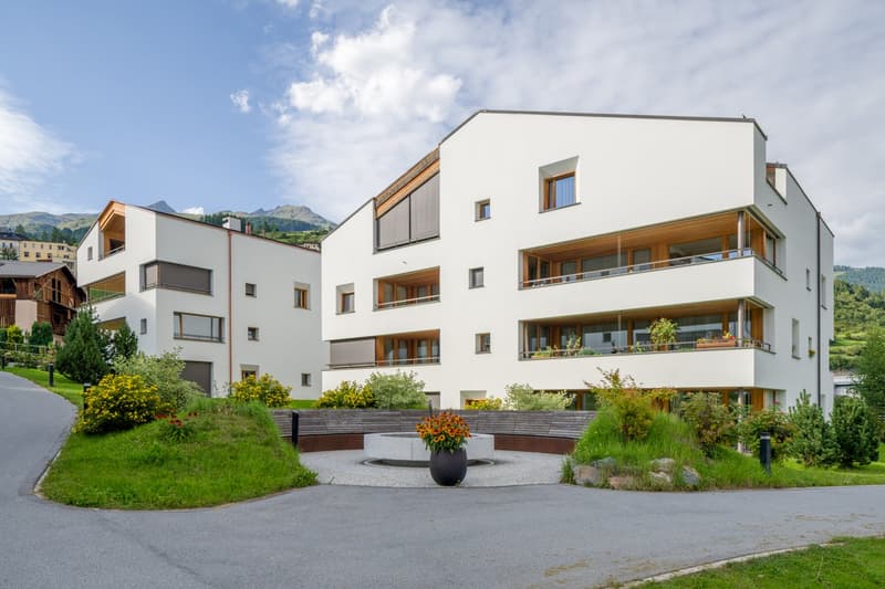 modern white architecture, balconies, grassy surroundings, entrance road, greenery