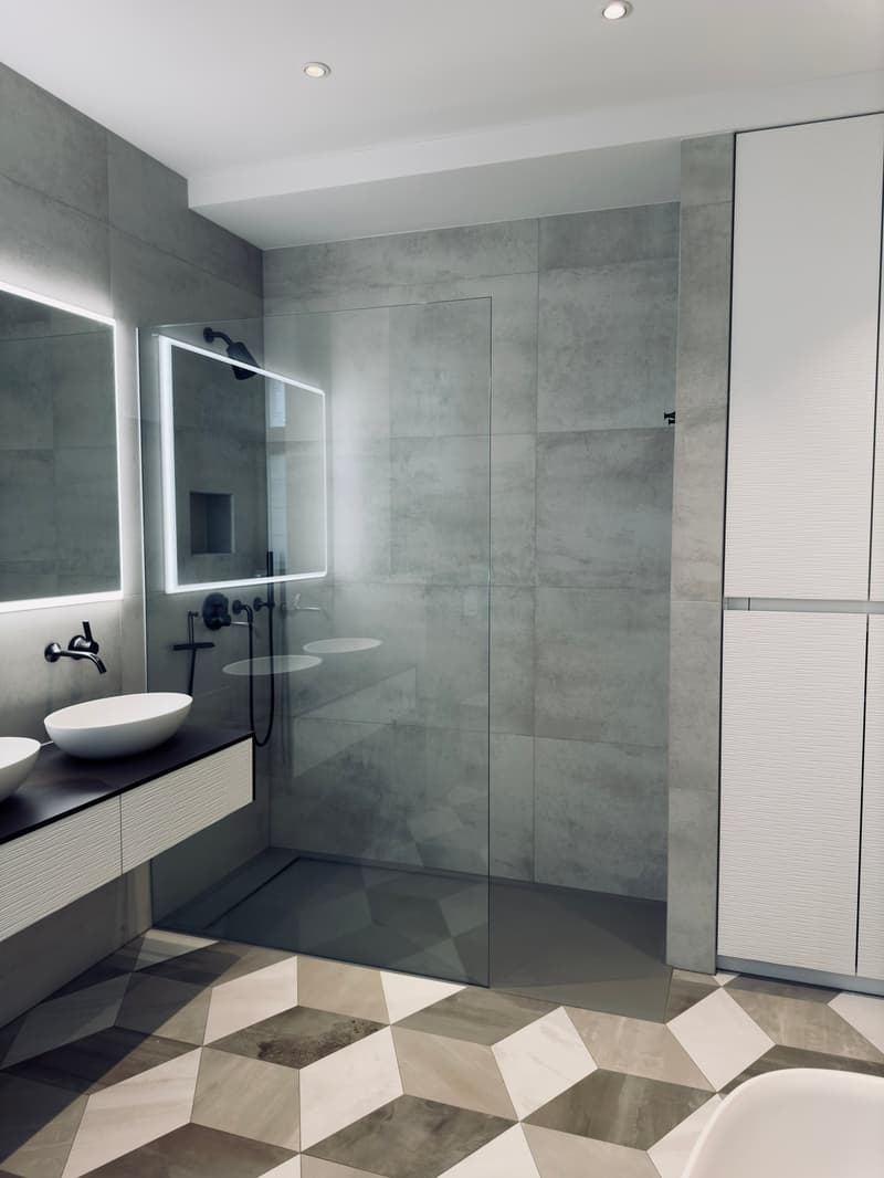 tiled floor, gray walls, glass shower enclosure, sinks, mirrors, modern fixtures