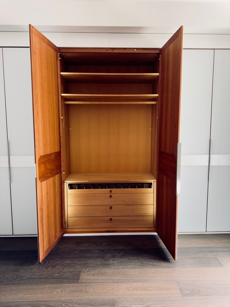 Wooden wardrobe with two large doors, hanging rail, drawers, wooden flooring