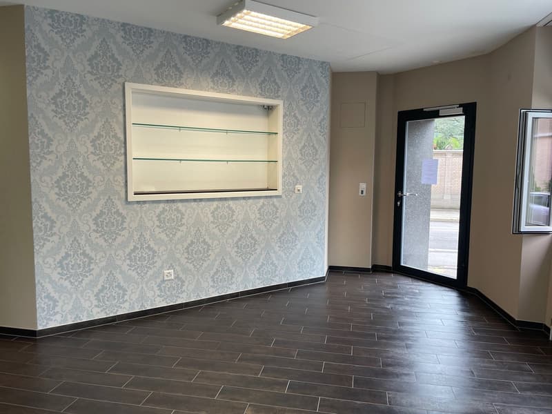 empty room, tiled floor, wall with decorative wallpaper, open door, ceiling with light